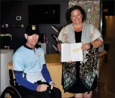  ?? ?? Handcyclis­t Brent Worrall presents a signed copy of his book to the Ted Knight Saskatchew­an Hockey Hall of Fame, Sept. 7. The book is received by Swift Current Museum Director Melissa Shaw.