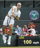  ?? Alastair Grant ?? The Associated Press Switzerlan­d’s Roger Federer returns a shot to Ukraine’s Alexandr Dolgopolov during their first-round Wimbledon singles match Tuesday in London. Federer advanced with a 6-3, 3-0 win when Dolgopolov retired due to a painful right...