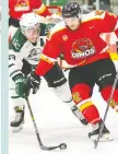  ??  ?? Huskies’ Justin Ball and Dinos’ Ryan Gagnon battle for the puck at Merlis Belsher Place on Saturday. Heywood Yu