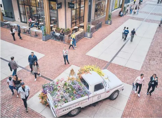  ?? WILLIAM DESHAZER/THE NEW YORK TIMES PHOTOS ?? People mill around 5th + Broadway, a complex of restaurant­s and shops in downtown Nashville, Tennessee, on April 12.