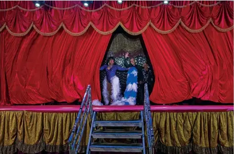  ?? AP PHOTO/ESTEBAN FELIX ?? Timoteo Circus performers Arturo Peña and and Juvenal Rubio wave goodbye Dec. 18 on closing night, on the outskirts of Santiago, Chile.