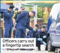  ??  ?? Officers carry out a fingertip search