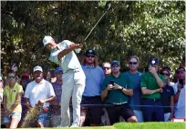  ?? AP Photo/ John Amis ?? ■ Tiger Woods tees off on the third hole during the second round of the Tour Championsh­ip Friday in Atlanta. Woods has a share of the lead ahead of the third round.