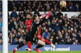  ?? Photograph: Carl Recine/Action Images/Reuters ?? Liverpool's Mohamed Salah dinks a delightful chip over Jordan Pickford to double Liverpool’s lead.