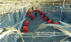  ??  ?? Processing some of the first detainees to arrive at Guantánamo Bay in Cuba, January, 2002. The facility once held more than 700 inmates, now only 40 remain. Photograph: US Navy/Getty Images