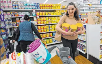  ?? Gregory Bull The Associated Press ?? Michelle Saenz of Santee, Calif., addresses the baby formula shortage in the United States by purchasing her supply at a grocery story in Tijuana, Mexico, on Tuesday.
