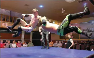  ?? Photo by J.W. Schnarr ?? Jumpin Josh hits a slingblade on Travis "The Heat" Copeland during their Pure Power Wrestling Cruiserwei­ght title match Saturday at the German Canadian Club of Lethbridge.