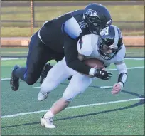  ??  ?? Royal Oak’s Ryan Buckheim, left, brings down Troy’s Nolan Block in the first half of Friday’s game. Troy defeated Royal for its first victory since a 20-12 win over Berkley on Oct. 19, 2018.