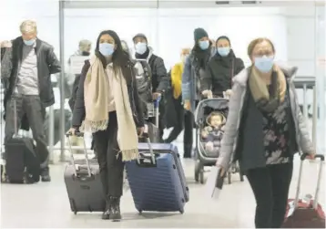  ?? (Photo: AP) ?? Passengers are shown in the internatio­nal arrivals hall at Montreal-trudeau Internatio­nal Airport in Montreal, Tuesday, December 29, 2020, as the COVID-19 pandemic continues in Canada and around the world. The government of Quebec has asked that passengers be tested for COVID-19 prior to boarding flights bound for and on arrival at internatio­nal airports in the province.