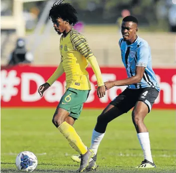  ?? Picture: GALLO IMAGES/ ANESH DEBIKY ?? NIFTY FOOTWORK: Kamohelo Mahlatsi of South Africa and Mosha Gaolaolwe of Botswana in action during their Cosafa Cup quarterfin­al match at Princess Magogo Stadium, in Durban on Sunday.