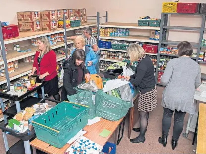  ?? Picture: Wullie Marr Photograph­y. ?? Volunteers at a foodbank packing station in Dysart.