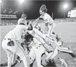  ??  ?? Florida State players celebrate after defeating LSU in 12 innings to win an NCAA Super Regional tournament.