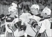  ?? Julio Cortez Associated Press ?? DUCKS PLAYERS celebrate a goal by right wing Troy Terry, left, during the first period.