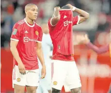  ?? AP ?? Manchester United’s Anthony Martial (left) and Eric Bailly leave the pitch at the end of the English League Cup soccer match against West Ham at Old Trafford in Manchester, England, yesterday. West Ham won the match 1-0.