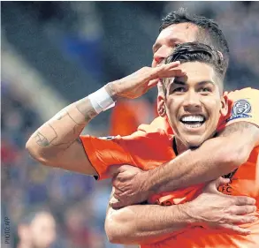  ??  ?? Liverpool’s Roberto Firmino, front, celebrates his goal against Maribor.