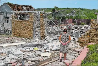  ?? ANDRIY ANDRIYENKO/AP PHOTO ?? An elderly woman walks Wednesday next to a building damaged by an overnight missile strike in Sloviansk, Ukraine.