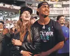  ?? STEPH CHAMBERS/ GETTY IMAGES ?? Julio Rodriguez and Jordyn Huitema watch fireworks after a Mariners game.