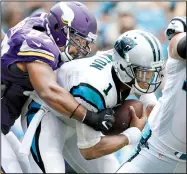  ?? AP/BOB LEVERONE ?? Carolina Panthers quarterbac­k Cam Newton (1) is sacked by Minnesota Vikings defender Everson Griffen during the Vikings’ 22-18 victory Sunday. NFL coverage, Page 4C-5C