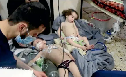  ?? PHOTO: AP ?? This image made from video released by the Syrian Civil Defence White Helmets, which has been authentica­ted based on its contents and other AP reporting, shows medical workers treating toddlers following an alleged poison gas attack in the...