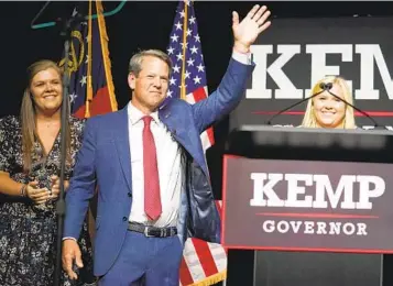  ?? JOHN BAZEMORE AP ?? Republican Gov. Brian Kemp waves to supporters during an election night watch party Tuesday in Atlanta. Kemp easily turned back a GOP primary challenge Tuesday from former U.S. Sen. David Perdue.