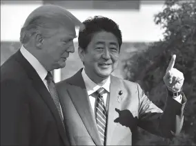  ?? FRANCK ROBICHON/XINHUA ?? U.S. President Donald Trump, left, is welcomed by Japanese Prime Minister Shinzo Abe upon his arrival at the Kasumigase­ki Country Club in Kawagoe, near Tokyo, Japan, on Sunday.