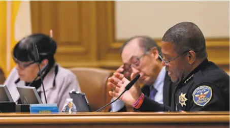  ?? Photos by Carlos Avila Gonzalez / The Chronicle ?? San Francisco Police Chief Bill Scott reads from a proposed Taser use policy during a Police Commission meeting at City Hall.