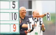  ?? Eric Risberg / Associated Press ?? Scorekeepe­rs at the 17th hole spell out “Tiger” as Tiger Woods passes their location during the completion of the second round of the 100th U.S. Open at Pebble Beach on June 17, 2000.