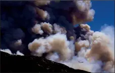  ?? LUIS SINCO/LOS ANELES TIME ?? A jumbo jet firefighti­ng plane is dwarfed by the smoke plume of the Apple Fire in the hills above Beaumont on Aug. 1.