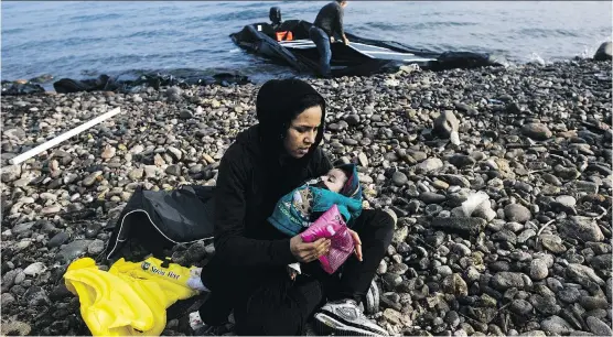  ?? DIMITAR DILKOFF/ GETTY IMAGES ?? A woman and child arrive on the Greek island of Lesbos after voyage from Turkey. The potential for another wave of refugees worries European officials.