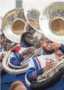  ?? AP ?? While the instrument­al musicians on the band’s album are from TSU, the vocalists include an all-star ensemble of chart-topping gospel singers like Donald Lawrence and Fred Hammond. Pictured: Members of the band perform during the Southern Heritage Classic football game in Memphis.