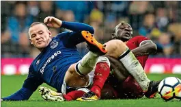  ??  ?? FULLY COMMITTED: Rooney tackles Sadio Mane in the Merseyside derby