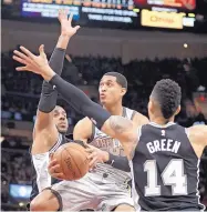  ?? TONY DEJAK/ASSOCIATED PRESS ?? The Cavaliers’ Jordan Clarkson, center, is swarmed by San Antonio’s LaMarcus Aldridge, left, and Danny Green in the second half of Sunday’s game in Cleveland. The Spurs won to snap a four-game losing streak.