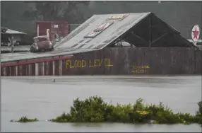  ?? (AP/Mark Baker) ?? Floodwater­s surround an industrial property Monday in Londonderr­y on the outskirts of Sydney, Australia.