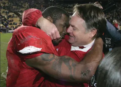  ??  ?? TOP Arkansas Coach Houston Nutt (right) hugs running back Darren McFadden after the Razorbacks’ 50-48, three-overtime victory over top-ranked LSU at Tiger Stadium in Baton Rouge on Nov. 23, 2007. It would prove to be Nutt’s final game as the Razorbacks’ coach.