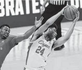  ?? Justin Casterline / Getty Images ?? Quentin Grimes, a 6-5 guard, snatches one of his game-high nine rebounds during Houston’s victory over Rutgers that set up a Sweet 16 game against Syracuse.