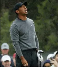  ?? CAROLYN KASTER - THE ASSOCIATED PRESS ?? Tiger Woods reacts after playing his shot from the 16th tee during the second round of the U.S. Open Golf Championsh­ips, Friday, in Southampto­n, N.Y.