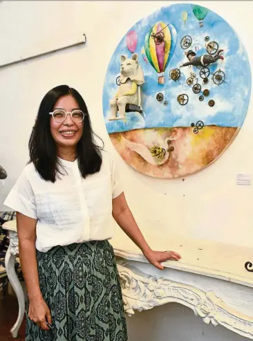  ??  ?? Wong posing with Forever Magician, which represents the present, past and future and is a homage to her beloved father. — Photos: GARY CHEN/The Star