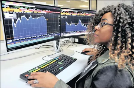  ?? PHOTO: TIMOTHY BERNARD ?? Mashudu Malema browses the Bloomberg terminal, eyeing the record leap in the all share index.