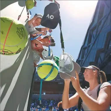  ?? REUTERS ?? Maria Sharapova of Russia signs autographs after her victory over Germany’s Tatjana Maria at the Australian Open on Tuesday. Sharapova received a warm welcome from fans in her first appearance at Melbourne Park since failing a dope test there in 2016.