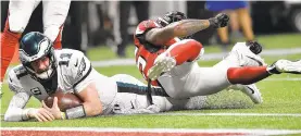  ?? JOHN AMIS/AP ?? Eagles quarterbac­k Carson Wentz hits the turf near the goal line as he comes up short on a two-point conversion attempt against the Falcons in the second half.