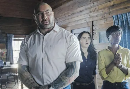  ?? UNIVERSAL PICTURES ?? From left, Dave Bautista, Abby Quinn and Nikki Amuka-Bird in Knock at the Cabin, the latest horror-thriller from M. Night Shyamalan.