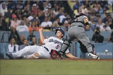  ?? Kevork Djansezian Getty Images ?? COREY SEAGER BEATS the tag of Arizona catcher Alex Avila and scores on a perfect safety squeeze bunt by Kenta Maeda in the fourth inning, giving the Dodgers a 4-0 lead over the Diamondbac­ks.