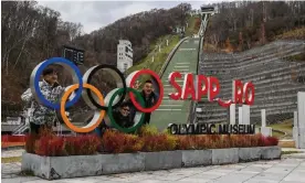  ?? Yuichi Yamazaki/AFP/Getty Images ?? People pose for a picture with the Olympic signage at the Sapporo Olympic Museum. The city is bidding for the 2030 Winter Games after previously hosting them in 1972. Photograph: