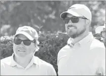  ?? Fred Conley • Times-Herald ?? At left, Justin Reeves lines up a putt for par during the EACC tournament played Monday at Forrest City Country Club. Above, Reeves visits with Barrett while posing for team photos during the tournament. The 10th tournament, to benefit the college’s Foundation, drew 23, four-person teams. As of press time, tournament results were unavailabl­e.