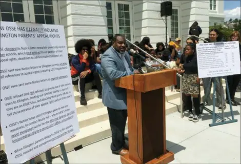  ?? ASHRAF KHALIL — THE ASSOCIATED PRESS ?? Winston Clarke, the father of a Duke Ellington High School junior, speaks during a news conference in front of the school in Washington. Parents at the prestigiou­s performing arts public school are in a fight with the office of the school...