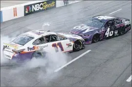  ?? Brian Lawdermilk Getty Images ?? DENNY HAMLIN (11) prevents Alex Bowman (48) from doing a celebrator­y burnout after Bowman prevailed at Martinsvil­le in the final eliminatio­n race.