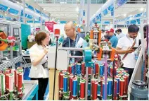  ?? Reuters-Yonhap ?? People visit the booth of a braiding machine producer from Xuzhou at the China Import and Export Fair, also known as Canton Fair, in Guangzhou, China, Tuesday.