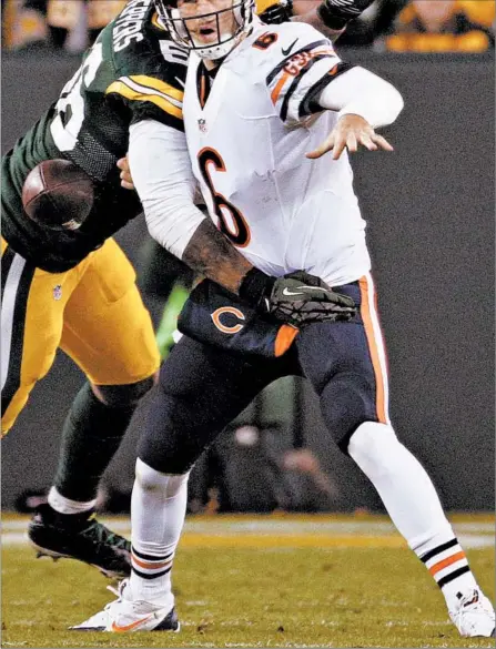  ?? CHICAGO TRIBUNE 2014 ?? ABOVE: Julius Peppers sacks Bears quarterbac­k Jay Cutler during a game in 2014. The Packers outscored the Bears 42-0 in that game at Lambeau Field, and Bears coach Marc Trestman was fired at the end of the season.