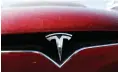  ?? Associated Press ?? ■ The Telsa logo shines on the grille of an unsold 2020 Model X at a Tesla dealership in Littleton, Colo.