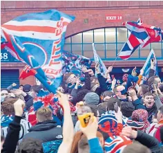  ??  ?? Fans were criticised when they gathered outside Ibrox after the title was clinched in March.